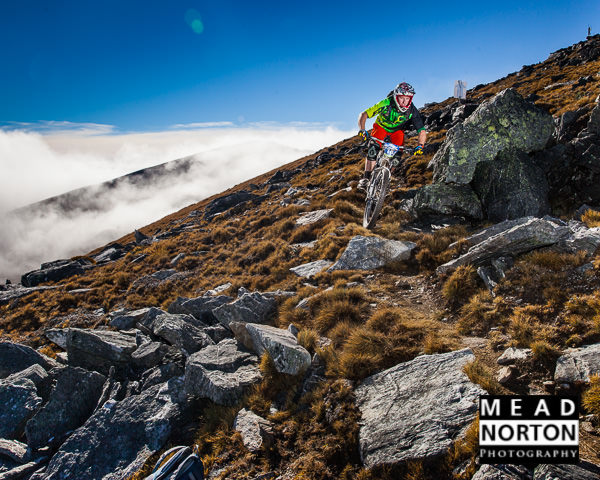 Higher res - Jimmy Pollard descnding off Summit of Mt Cardrona on race stage D - Photo Mead Norton