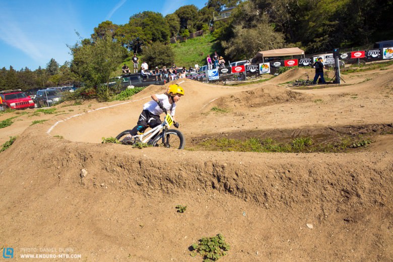 A very young rider ripping a bermed turn during the pump track speed race. These kids were shredders!