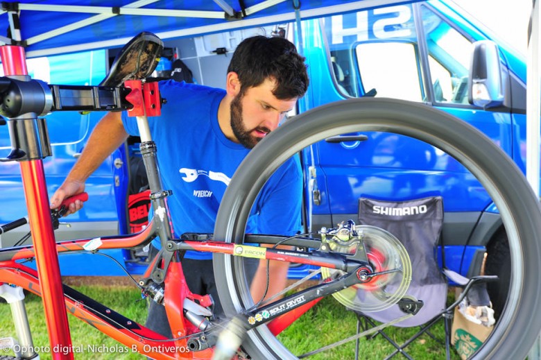Shimano all around great guy Tyler West works in the mechanic's tent before heading out on his own race run. 
