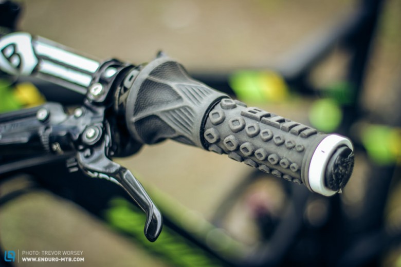 The WTB Moto - X grips offer tenacious grip, they are pretty wide at 35mm, but the large knobs help when your arms are like noodles.  Jerome runs his travel adjust from a grip shift.
