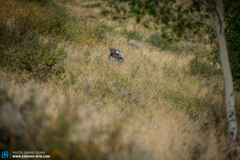 Sarah Rawley riding through a sea of tall grass on the Caves trail, Stage 7. 