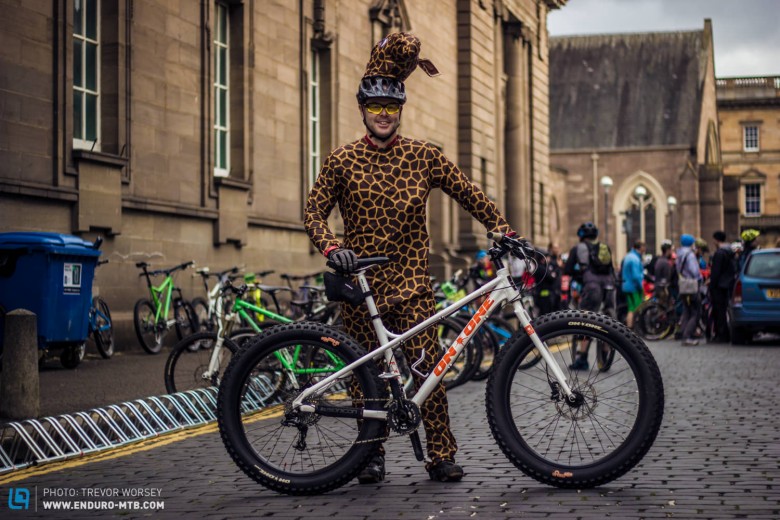 At first it looks like a friendly giraffe, but why has he only one ear?  He is also riding a fancy dress bike!