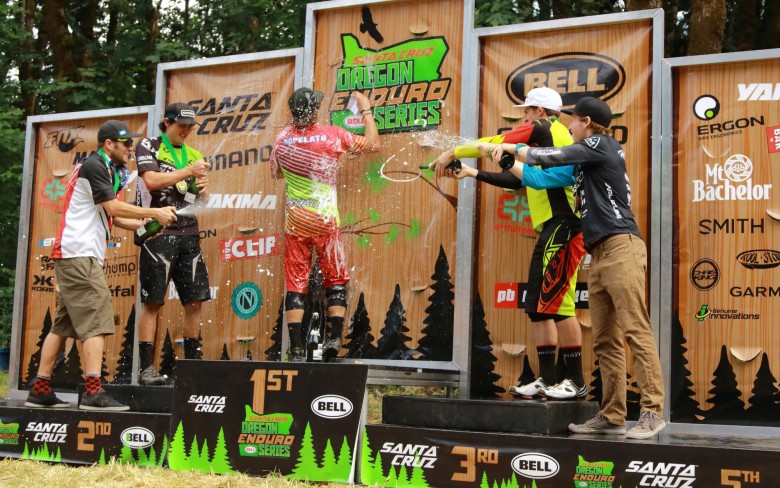 The pro men sneak up on the 1rst place rider Mitch Ropelato and drench him with some victory champane. 