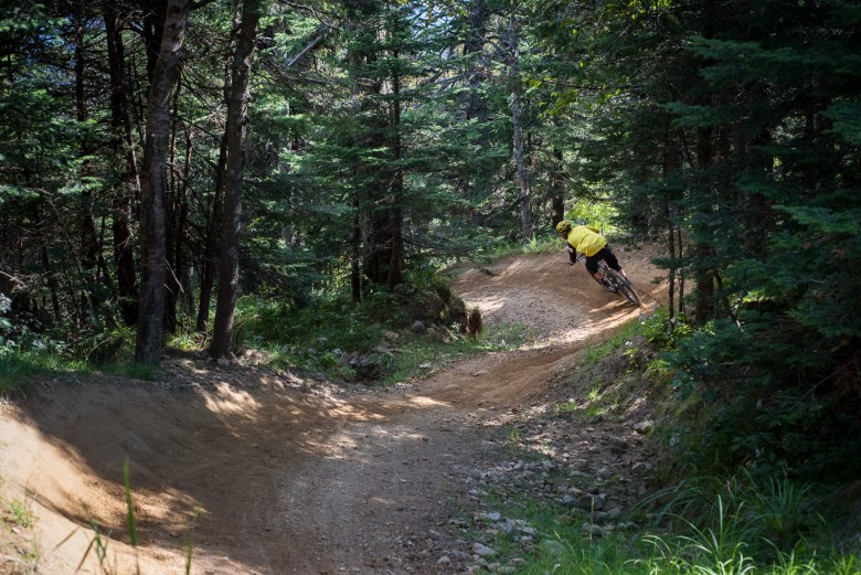 A split second break from pedaling through a perfect set of berms.
